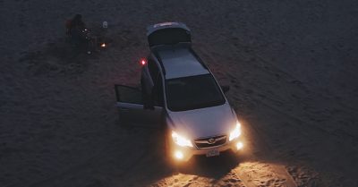 Image Of Subaru With Turned On Headlights On The Beach At The Sunset