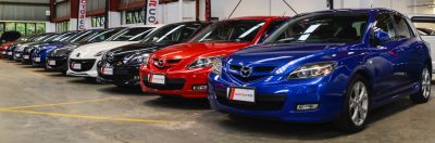 Image Of the Mazda 3 cars of different colours displaying in a row in the car yard